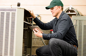 Service tech repairing an AC unit