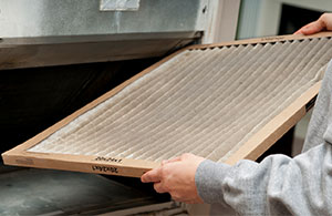 Person holding dirty HVAC filter