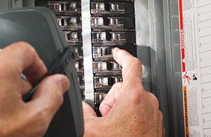 Person turning on circuit breaker