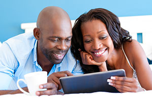 Couple smiling looking at iPad