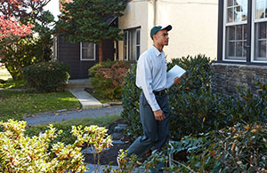 Service tech approaching a house