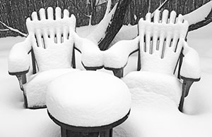 Back yard furniture covered in snow